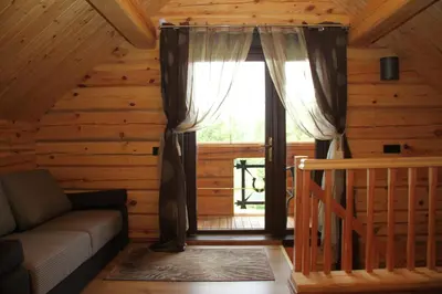 a living room with a couch and a window at Namukas su ežero pakrante Trakai ,Viesų vila in Salkininkai