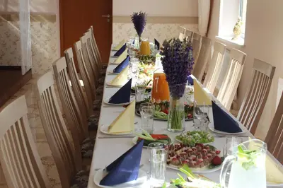 a long table with plates of food on it at Hotel Angelas in Utena
