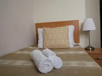 a bedroom with a bed with towels on it at Hotel Angelas in Utena