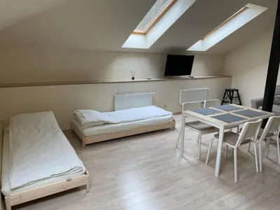 a room with a bed and a table and chairs at Laura in Vilnius