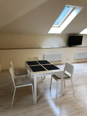 a room with a table and chairs and a skylight at Laura in Vilnius