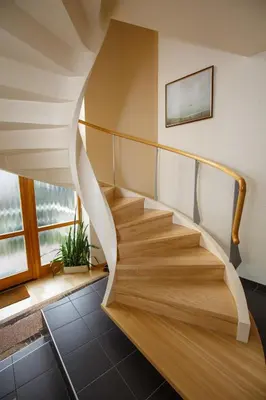 a spiral staircase in a house with a window at Laura in Vilnius