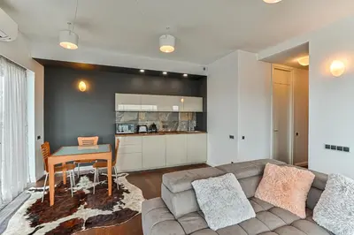 a living room with a couch and a table at Vilnius city best view apartments in Vilnius
