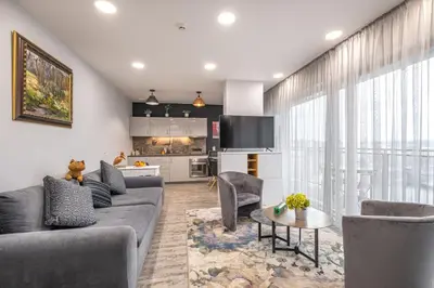 a living room with a couch and a table at Vilnius city best view apartments in Vilnius