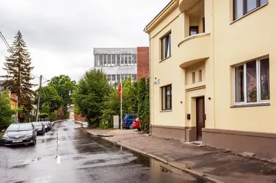 a street with cars parked on a rainy street at Bright and Cosy 1BDR apartment Kaunas Centre in Kaunas