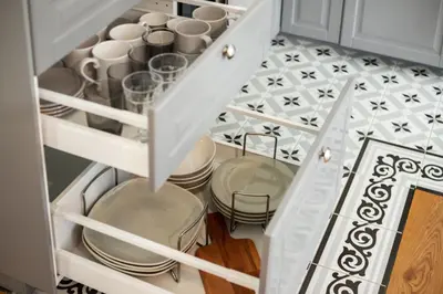 a kitchen with plates and dishes in a drawer at Bright and Cosy 1BDR apartment Kaunas Centre in Kaunas