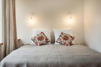 a bedroom with a bed with two pillows on it at Bright and Cosy 1BDR apartment Kaunas Centre in Kaunas