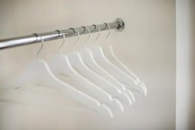 a bunch of white hangers in a closet at Bright and Cosy 1BDR apartment Kaunas Centre in Kaunas