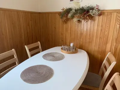 a white table with chairs and a white table with glasses on it at Old Town apartment in Kaunas