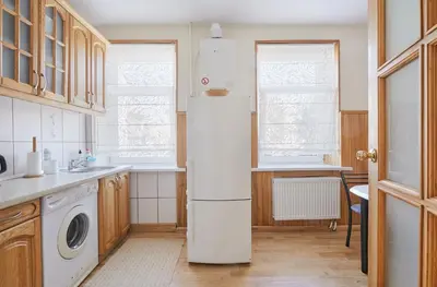 a kitchen with a refrigerator and a sink at Old Town apartment in Kaunas