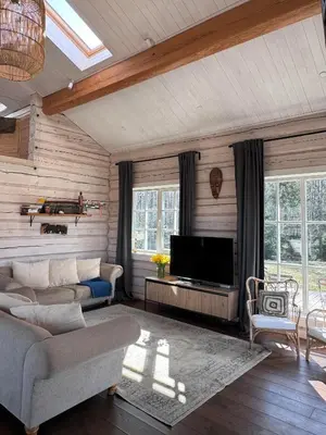 a living room with a couch and a tv at Aviečių vila in Sumiliszki