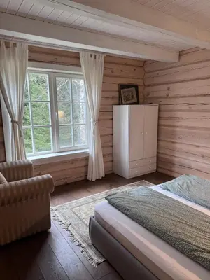 a bedroom with a bed and a window at Aviečių vila in Sumiliszki