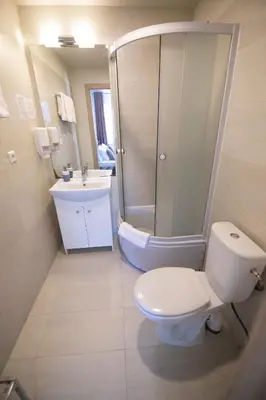 a bathroom with a toilet and a shower and a sink at Svečių Namai TEN in Marijampolė