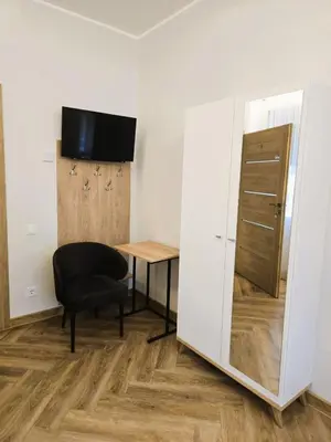 a small room with a desk and a mirror at Svečių namai 