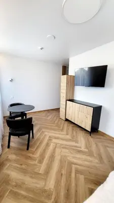 a living room with a table and a desk at Svečių namai 