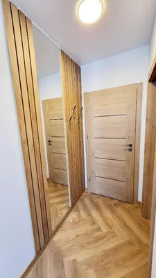 a room with two closet doors and a wooden floor at Svečių namai 