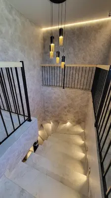 a staircase in a building with a bench and lights at Svečių namai 