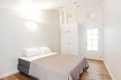 a white bedroom with a bed and a window at Twin apartments 3 Bedr by Reside Baltic in Vilnius