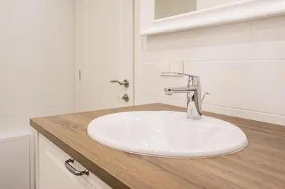 a white sink in a bathroom with a counter at Twin apartments 3 Bedr by Reside Baltic in Vilnius
