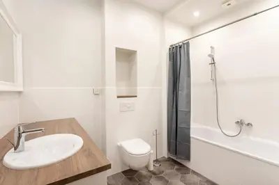 a bathroom with a sink and a toilet and a shower at Twin apartments 3 Bedr by Reside Baltic in Vilnius