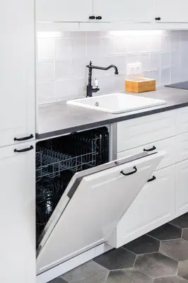 a dishwasher in a white kitchen with a sink at Twin apartments 3 Bedr by Reside Baltic in Vilnius