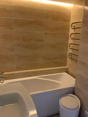 a bathroom with a bath tub and a toilet at Alytus Apartament in Alytus