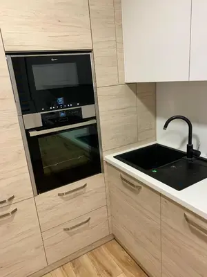 a kitchen with a microwave oven and a sink at Alytus Apartament in Alytus