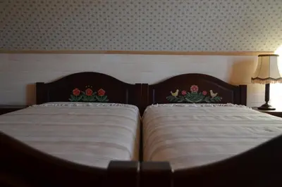 two beds sitting next to each other in a bedroom at Sodyba Širvynė in Užpaliai