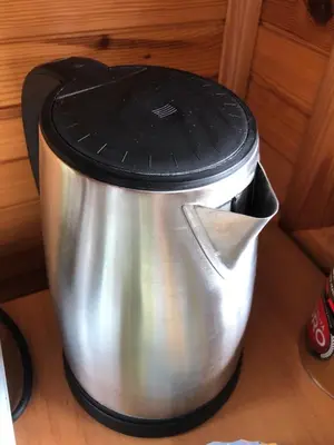 a pot with a black top on top of it at Paukoje Apartamentai in Ignalina