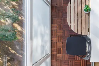 a black chair sitting next to a wall with a window at Sun City Apartment in Šiauliai