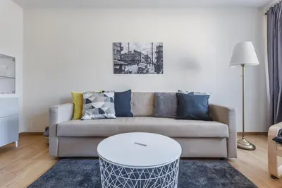 a living room with a couch and a table at Sun City Apartment in Šiauliai
