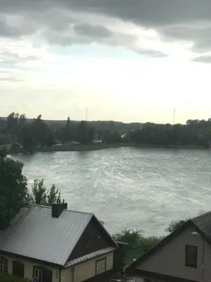 a view of a body of water with a house at Cozy apartment with lake view in Trakai