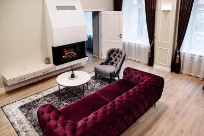 a living room with a couch and a table and a fireplace at Kranto apartaments in Panevėžys
