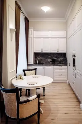 a kitchen with a table and chairs in a room at Kranto apartaments in Panevėžys