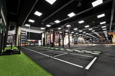 a large room with a gym with grass on the floor at Zaliakalnio terasos apartamentai in Kaunas