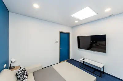 a living room with a couch and a tv at Zaliakalnio terasos apartamentai in Kaunas