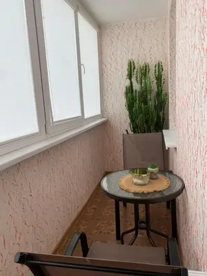 a small table in a room with a plant at Trumpalaikė buto nuoma,apgyvendinimas - bekontaktis įėjimas in Rokiškis