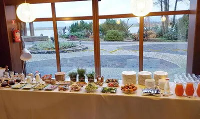 a table with food and drinks on top of it at KARPYNĖ Restaurant & Bed & Breakfast in Gabšiai