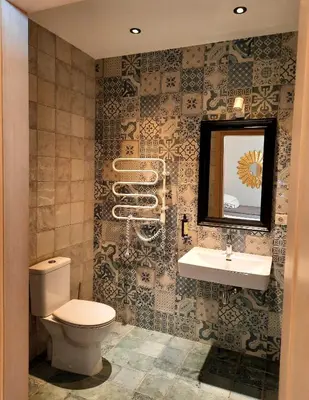 a bathroom with a toilet and a sink at Lake & Library boutique Hotel in Ignalina