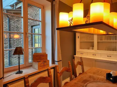 a dining room with a table and a chandelier at Lake & Library boutique Hotel in Ignalina
