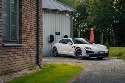 a white car parked in front of a building at Lake & Library boutique Hotel in Ignalina