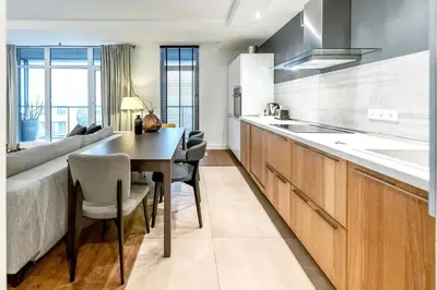 a kitchen with a dining table and a couch at Vilnius Apartments & Suites in Vilnius
