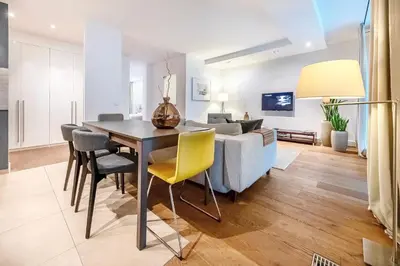 a living room with a dining room table and a couch at Vilnius Apartments & Suites in Vilnius