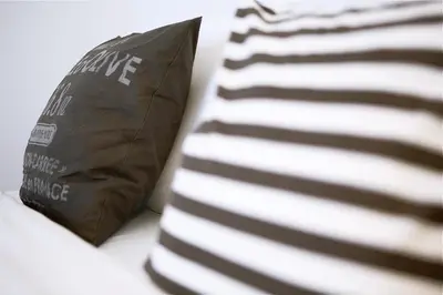 a bag sitting on a table next to a pillow at Vilnius Apartments & Suites in Vilnius