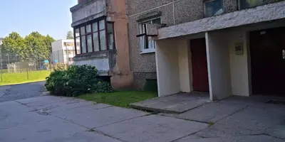 an old building with a red door on the side of it at KAMBARIŲ nuoma Kaune - in Kaunas