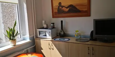 a room with a television on a wooden cabinet at KAMBARIŲ nuoma Kaune - in Kaunas