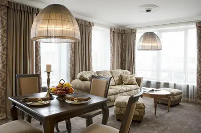 a living room with a table and a couch at Ursula Royal Apartments in Druskininkai