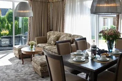 a living room with a table and a couch at Ursula Royal Apartments in Druskininkai