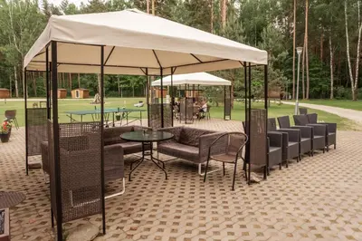 a group of chairs and tables under a tent at Camping & Camper place Pasvalys in Pasvalys
