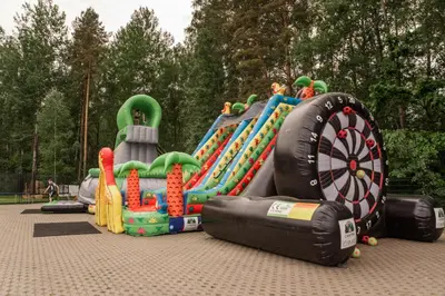 a large inflatable playground with a dart board and an inflatable game at Camping & Camper place Pasvalys in Pasvalys